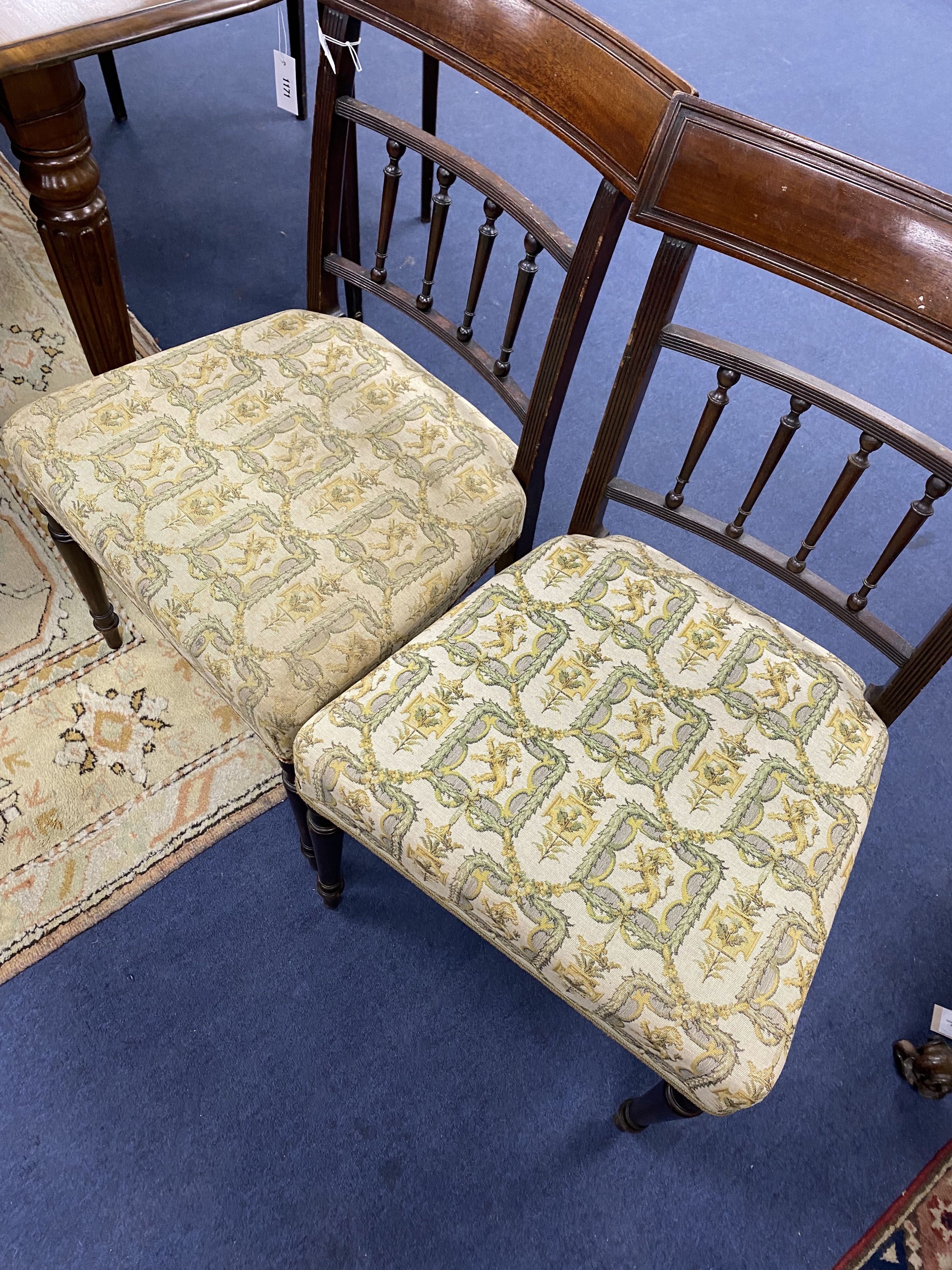 A set of four George III mahogany dining chairs